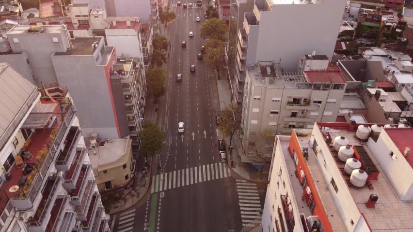 Cars driving along Cordoba avenue in Buenos Aires city at sunset, Argentina. Aerial drone static view