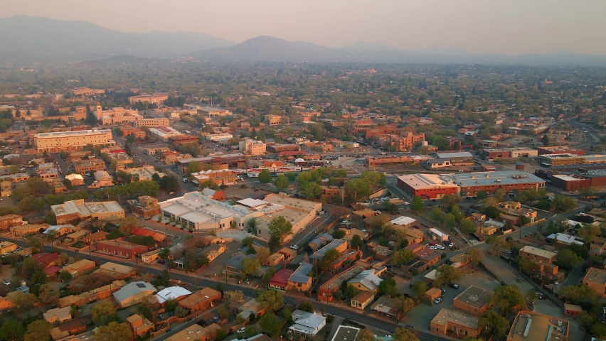 Aerial view overlooking the downtown of Santa Fe, hazy evening in NM, USA - tracking, drone shot