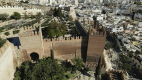 Drone flying around towers of Almeria complex fortified in Spain. Aerial orbiting