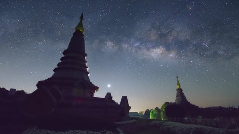 Time Lapse 4K of The Milky Way Galaxy moving over a sacred temple at Doi Inthanon National Park, Chiang Mai, Thailand. Night lapse from night to day. Starry night.	