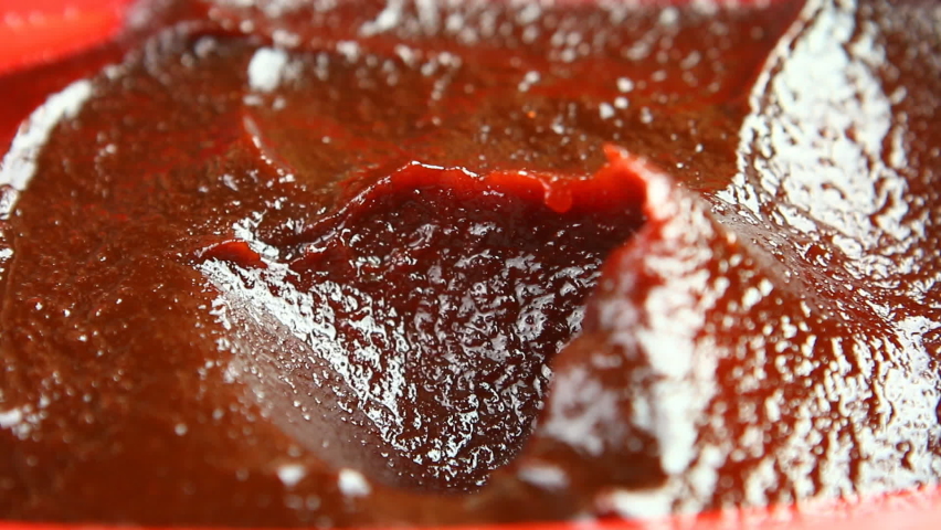 Man is scooping Korean chili paste or Gochujang, in studio Chiangmai Thailand