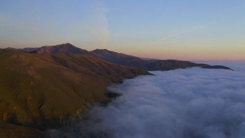 Drone Shots of Pacific Coast Cliffs near Big Sur and Carmel Highlands California during Marine Fog Layer and Sunset. Beautiful 4K Drone footage of Highway 1 Fog. One of 11 in this series.