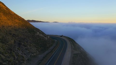 Drone Shots of Pacific Coast Cliffs near Big Sur and Carmel Highlands California during Marine Fog Layer and Sunset. Beautiful 4K Drone footage of Highway 1 Fog. One of 11 in this series.