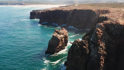 The Atlantic Ocean crashing onto the vertical cliff face along the West Coast of Portugal 