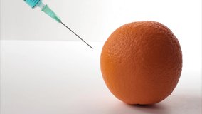 Poisoned foods. Poisoned orange. Poisonous substance in a syringe. Blue liquid injection. Yellow orange and syringe. - Powered by Shutterstock - Get 15% off with code: PIKWIZARD15