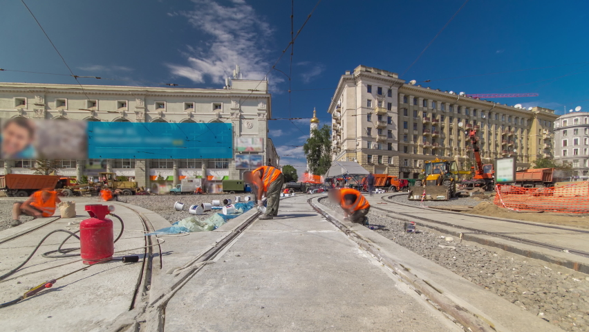 Tram rails at the final stage of their installation and integration into concrete plates on the road panoramic timelapse. Filling by liquid resin for reduction of vibration and noice. The process of
