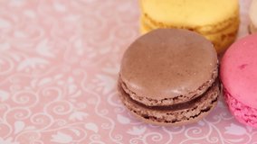 several macaroons on a pink background