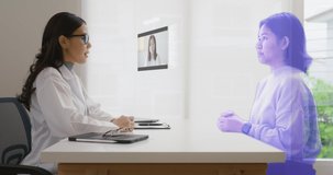 Medical specialist having conversation with patient at appointment in Doctor office. Online Conference Call from asian patient. Futuristic online Distant telehealth, telemedicine. Hologram Concept