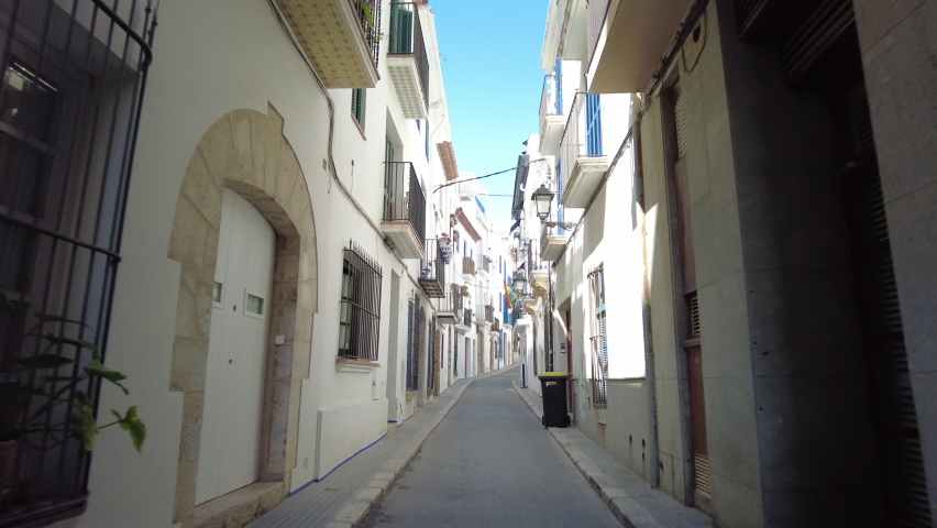 Walking on a narrow street in Sitges, Costa Dorada in Catalonia, spain Royalty-Free Stock Footage #1090612701