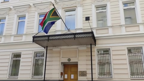 Moscow, Russia - 04.28.2022: South African embassy in Moscow, Russia. Waving South African national flag during daylight. 
Translation: South African embassy 