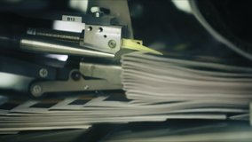 Technology of fully automated press machine in typography. Industrial equipment of print industry operating during daily newspaper production. High quality FullHD footage