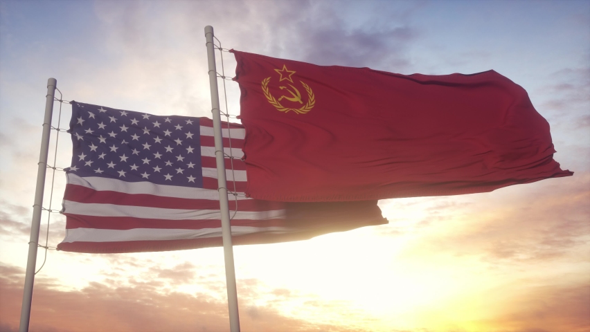 URSS Soviet Union and United States flag waving at wind at sunset. The Cold War
