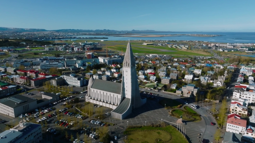 Aerial view of the Hallgrimskirkja Church in Reykjavik. Scenic view of Iceland in 4k. Hallgrimskirkja Lutheran Church. Statue of Leif Eriksson. Royalty-Free Stock Footage #1090618037