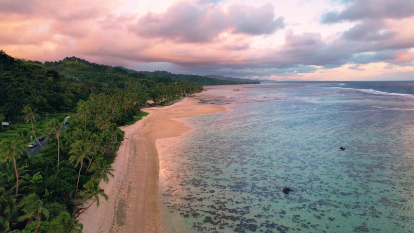 Fiji aerial footage warm sunset afternoon light over sandy beach tropical Royalty-Free Stock Footage #1090618699