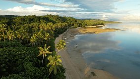 Fiji aerial footage warm sunset over sandy beach tropical paradise at Maui Bay