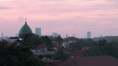 8K Timelapse Sequence of Surabaya, Indonesia - The city of Surabaya from day to night with a mosque in the foreground