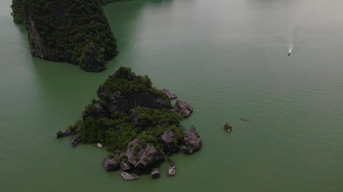 Drone tilt up, Phang Nga bay, boat spotted. Thailand