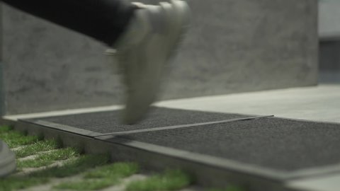 Video footage of the process of cleaning footwear before entering the toilet and after leaving the toilet. Doormat made of feet, usually placed at the entrance to the room.