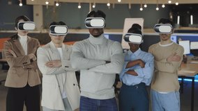 Front view of successful multiracial business team posing in VR headset in modern creative office. Five confident friendly coworkers looking at camera and keeping arms crossed. - Powered by Shutterstock - Get 15% off with code: PIKWIZARD15