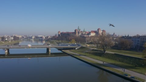 Aerial drone video footage of Krakow Poland. Grunwaldzki bridge at Vistula river,  Wawel castleat the background in Cracow. relaxed morning mood