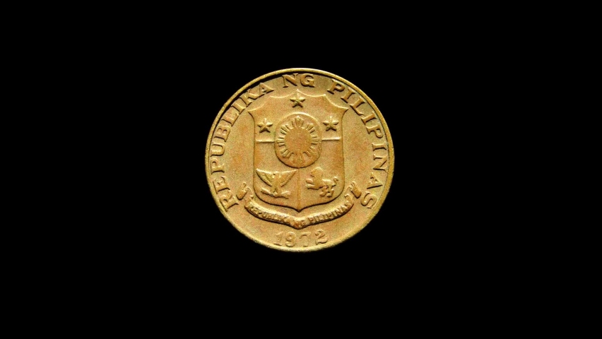 Rotating obverse of Philippines coin 5 sentimos 1972. Isolated in black background.