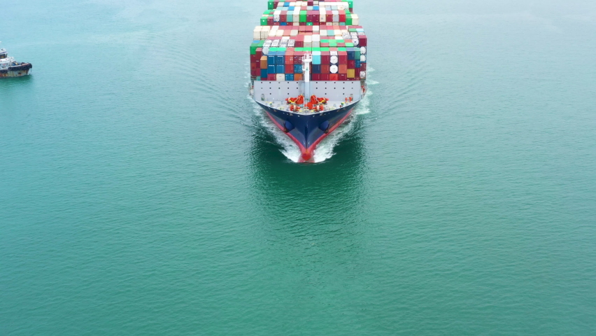 Aerial front view Container Cargo Ship carrier container from commercial port for business logistics, import export international by shipping freight transportation and worldwide, from drone 4k video
