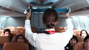 Asian beautiful female flight attendants explaining passengers how to use seat belt fastening in emergency situation flight attendants in uniform safety demonstration concept airplane.Aircraft safety. - Powered by Shutterstock - Get 15% off with code: PIKWIZARD15