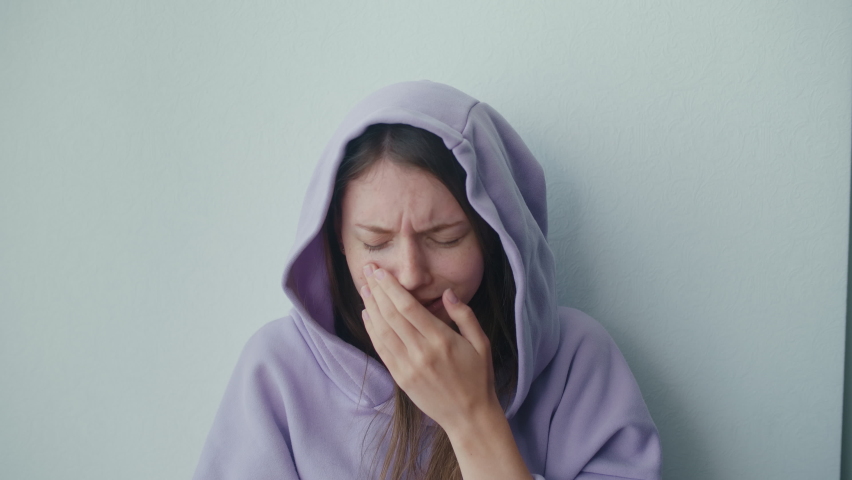 Unhappy Depressed Teenager Girl Wears Hood Sits Alone Thinking of Problem. Crying Sensitive Lonely Adolescent Teen Feeling Worried and Hurt at Home. Teenage Psychological Trauma, Complex Concept. | Shutterstock HD Video #1090634491