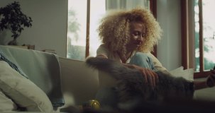 Portrait of Beautiful Brazilian Young Woman Ending a Video Call on her Phone and Petting Her Adorable Cat at Home. Girl Talking to Her Fluffy Cat and Having Fun in the Living Room. Slow Motion