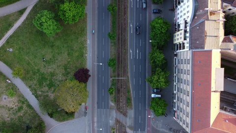 Cars drive in both directions on Prenzlauer Allee cyclists Stunning aerial view flight bird's eye view drone footage of Berlin Prenzlauer Berg Summer 2022. Cinematic travel guide by Philipp Marnitz
