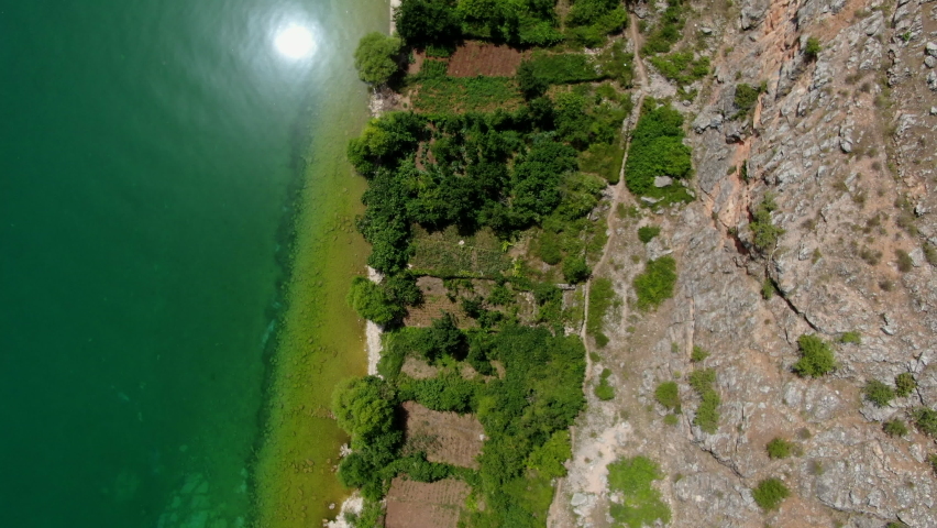 Beautifu cenital l Aerial Shot in Podgradec Lake Ohrid, peninsula Lin, Podgradec in Albania.