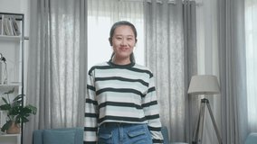 Asian Woman Dancing While Shooting Video Content For Social Networks At Home
