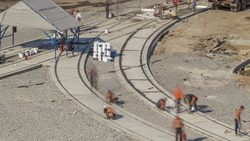 Tram rails at the final stage of their installation and integration into concrete plates on the road timelapse. Filling by liquid resin for reduction of vibration and noice. The process of