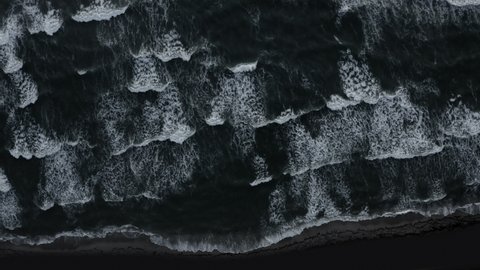 Top view of stormy sea wave texture isolated on black background. Powerful stormy sea ocean waves top-down view drone shot. Aqua sea water surface aerial view.