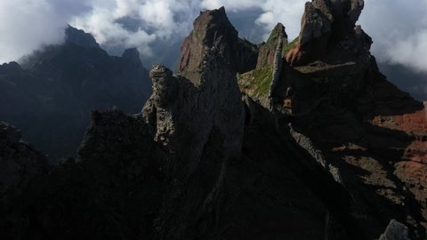 Drone shot moving forwards between the peaks of Pico das Torres in Madeira.