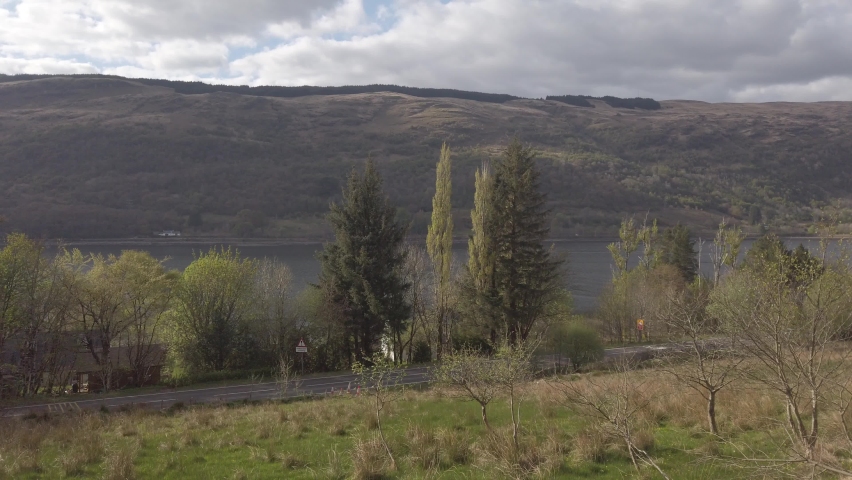 Cars go by on the road below.