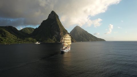 The Royal Clipper sailing along Saint Lucia's beautiful coast, with the Pitons in the background. Drone footage of The Royal Clipper, one of the biggest sailing vessels in the world.