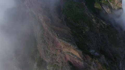 Drone shot looking down and moving forward over the ridge of Pico das Torres in Madeira.