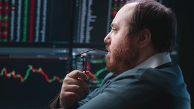 Close up of pensive fat trader look at multiple computer screens with data. Broker analyze stock market charts and thinking - Powered by Shutterstock - Get 15% off with code: PIKWIZARD15