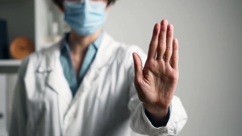 Hand gesture stop, sign restriction hand turned palm up. Doctor shows no with hand symbolizing stop, Stop violence and negativity, Say no to illness to abortion
