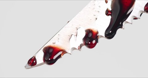 Blood dripping from stainless steel knife on white background.