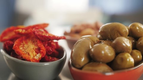 Italian cuisine with traditional snacks, delicious tapas, olives, dried tomatoes.