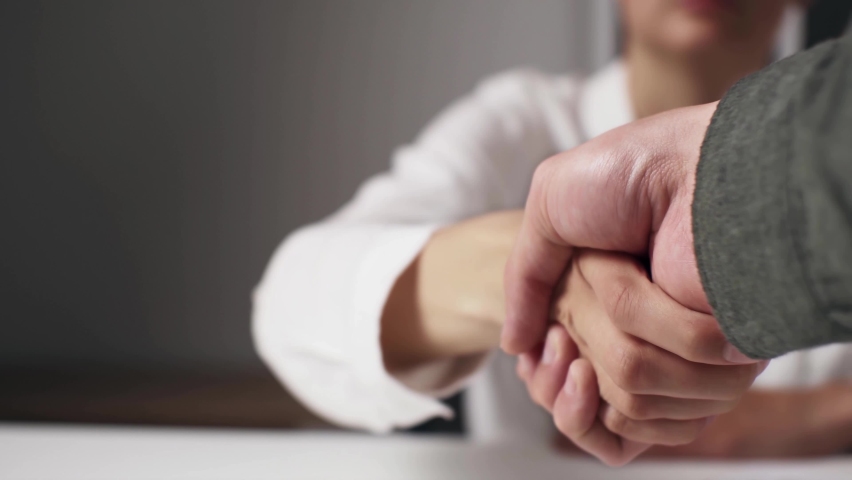 The client visitor shakes hands with the doctor insurer thanks to him for the good service and the deal that was beneficial for both, Hand shakes hands greeting gratitude approval of the deal
 | Shutterstock HD Video #1090653371