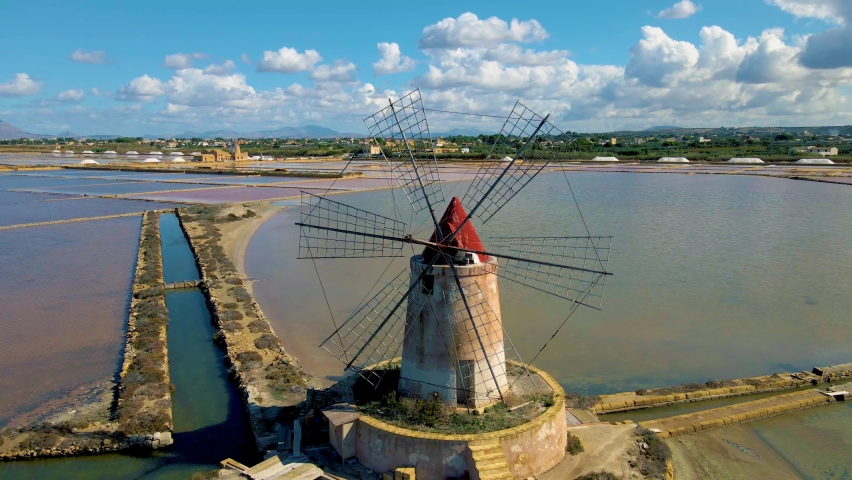 Trapani windmills, Natural reserve of the Saline dello Stagnone, near Marsala and Trapani, Sicily., Aerial picture of Trapani salt evaporation ponds and salt mounds windmill  in Sicily Royalty-Free Stock Footage #1090657721