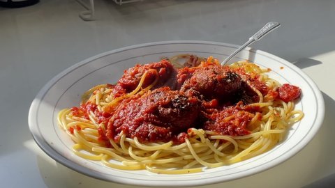 Spaghetti noodles and meatballs on white plate