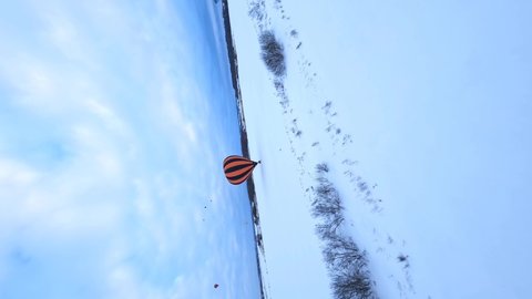 FV Vertical 4k Aerial View of Hot Air Balloon Parachute and Basket in Snow in Cold Winter Landscape, Drone Shot 50fps