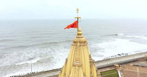 somnath , Gujarat , India - 05 24 2022: Aerial rotating shot of the top of Somnath mandir with trisula situated, Aerial view of the Somnath temple located in Prabhas Patan, Veraval in Gujarat, India,1