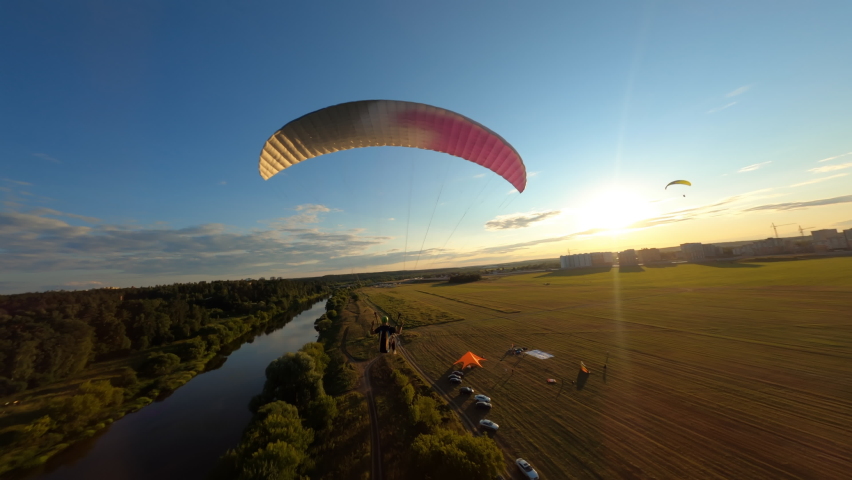 Aerial shot of paraglider flying along the river drone flies above his head Royalty-Free Stock Footage #1090668865