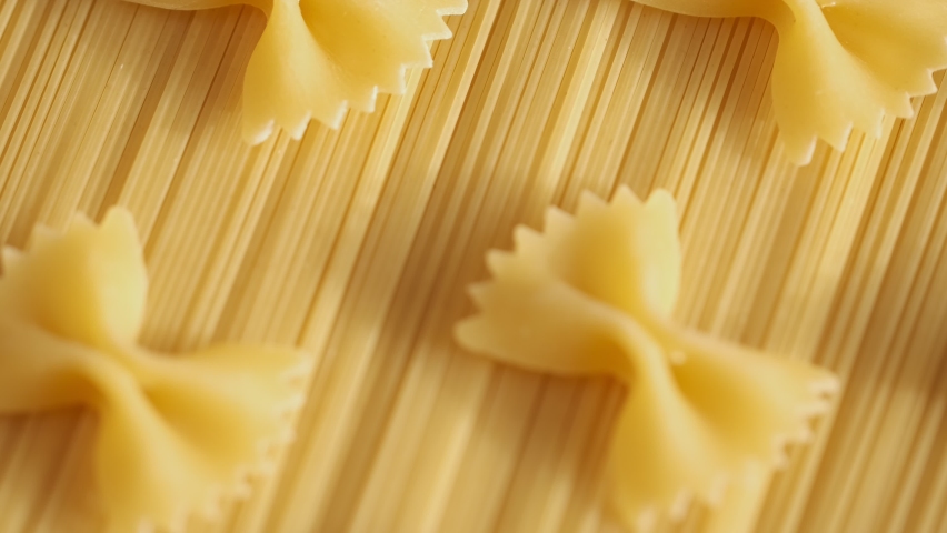Background Of Spaghetti Pasta. Uncooked Italian Pasta Golden Rotating Backdrop. Healthy Eating Concept. Raw Dried Organic Pasta. Long Macaroni, Rotating Background. Italian Culture