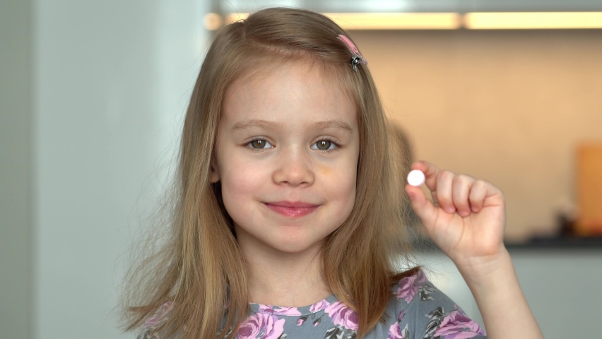Happy little girl holds pill in hands and fun eats vitamin. Medicines, medicament and drug. Health, care and treatment for children. Royalty-Free Stock Footage #1090673961